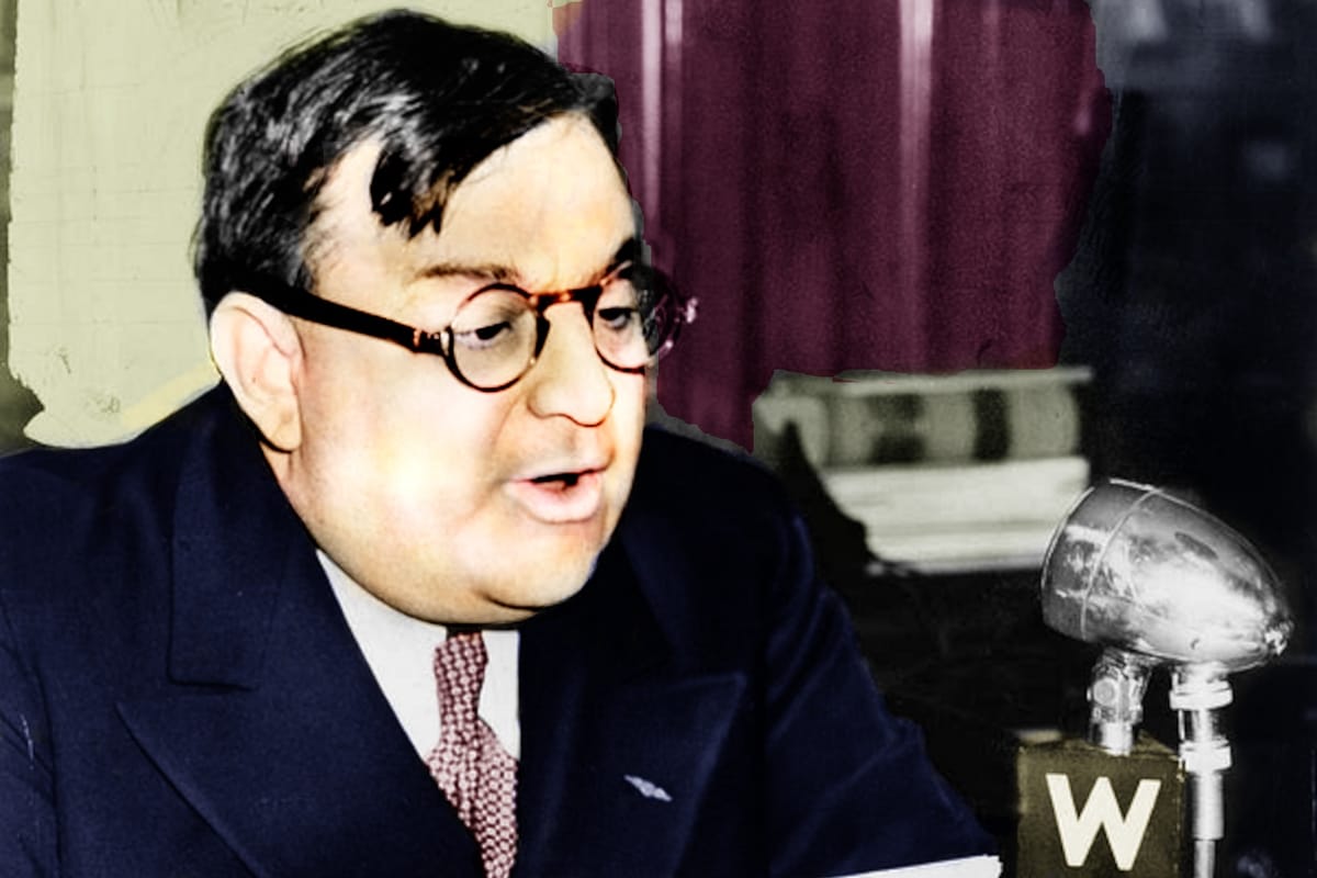 New York City Mayor Fiorello LaGuardia, with eyeglasses and short, dark hair reads off a paper into a 1930s microphone for radio broadcast. It is colorized from a black-and-white photograph.